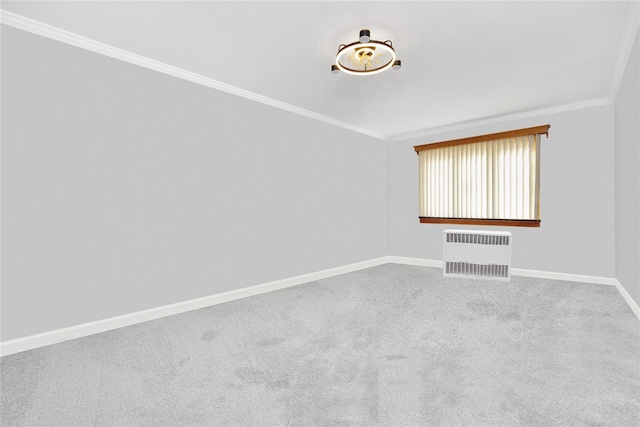 spare room featuring carpet, radiator heating unit, and ornamental molding