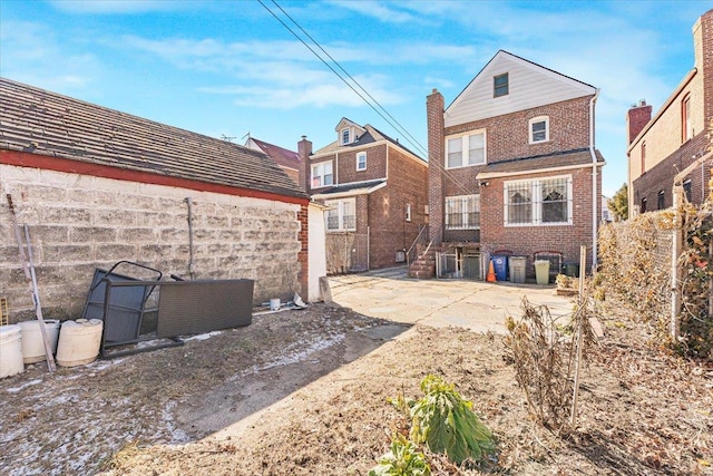 back of property featuring brick siding