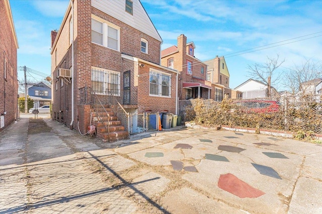 back of property featuring brick siding