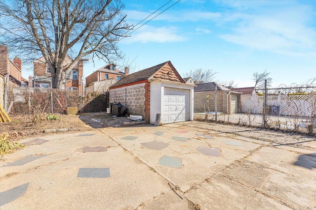 detached garage with driveway and fence