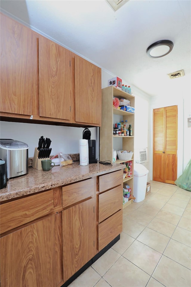 kitchen with light stone countertops and light tile patterned floors