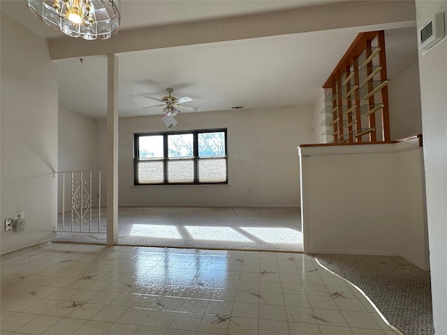 unfurnished living room featuring light carpet and ceiling fan