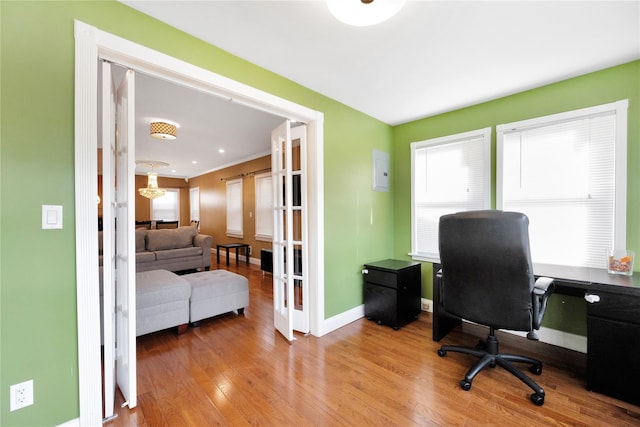 home office with french doors and light hardwood / wood-style flooring