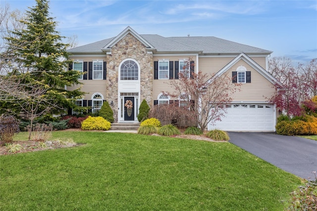 view of front of home featuring a front yard and a garage