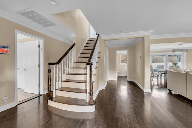 entrance foyer with crown molding and dark wood-type flooring