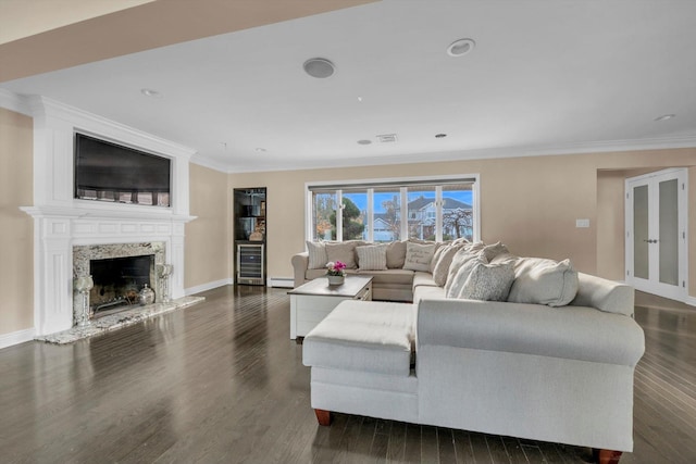 living room with dark hardwood / wood-style floors, crown molding, a fireplace, and beverage cooler