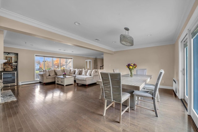 dining area featuring baseboard heating, wine cooler, crown molding, and hardwood / wood-style floors