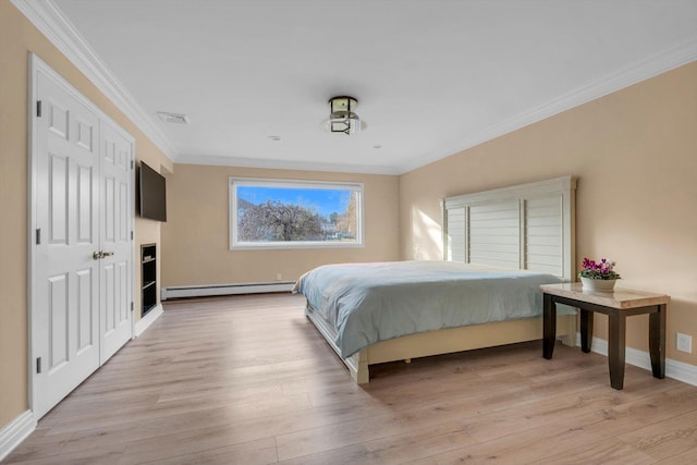 bedroom with ornamental molding, light hardwood / wood-style flooring, and a baseboard heating unit