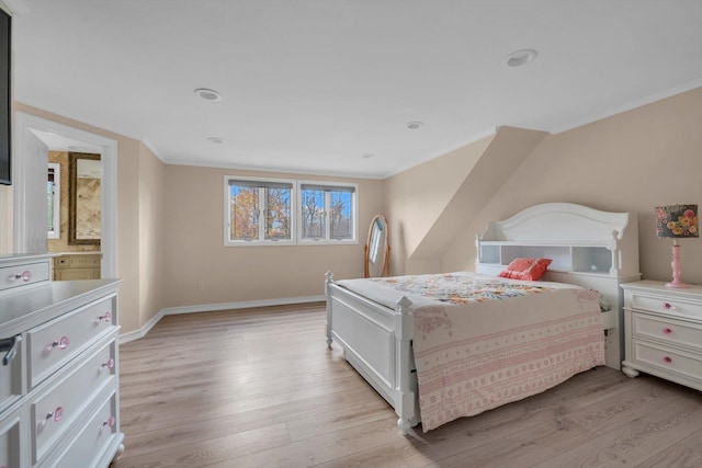 bedroom featuring multiple windows, ornamental molding, and light wood-type flooring