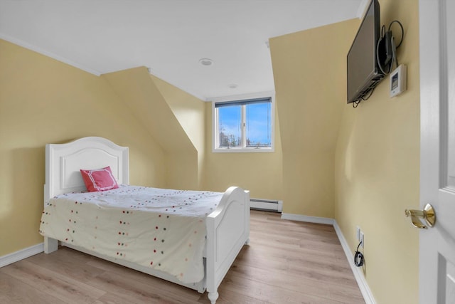 bedroom featuring light wood-type flooring and a baseboard radiator