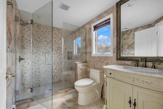 bathroom featuring walk in shower, vanity, tile walls, and toilet