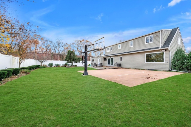 rear view of house with a lawn and central AC unit