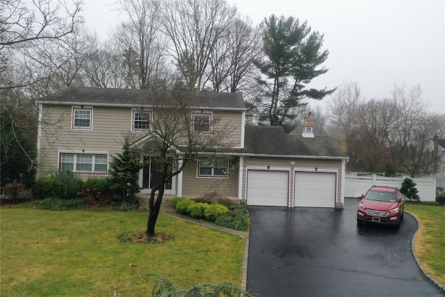 view of front property with a front lawn and a garage