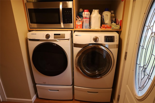 washroom featuring washing machine and dryer