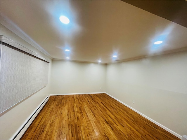 interior space featuring baseboard heating and wood-type flooring