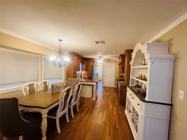 dining area with dark hardwood / wood-style flooring, crown molding, and ceiling fan with notable chandelier