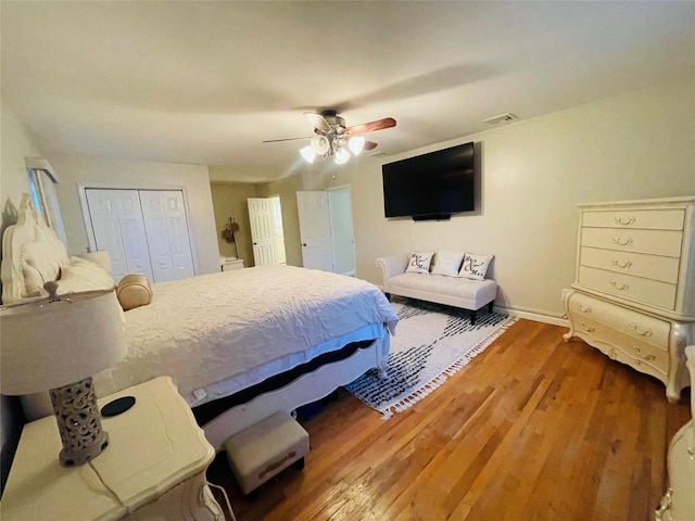 bedroom featuring ceiling fan, a closet, and wood-type flooring