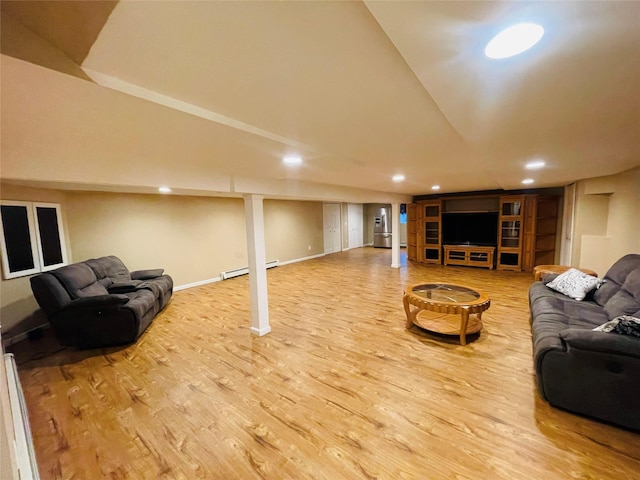 living room with wood-type flooring and a baseboard heating unit