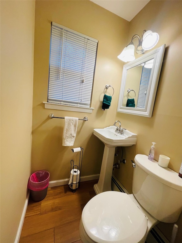 bathroom with toilet, sink, and hardwood / wood-style flooring