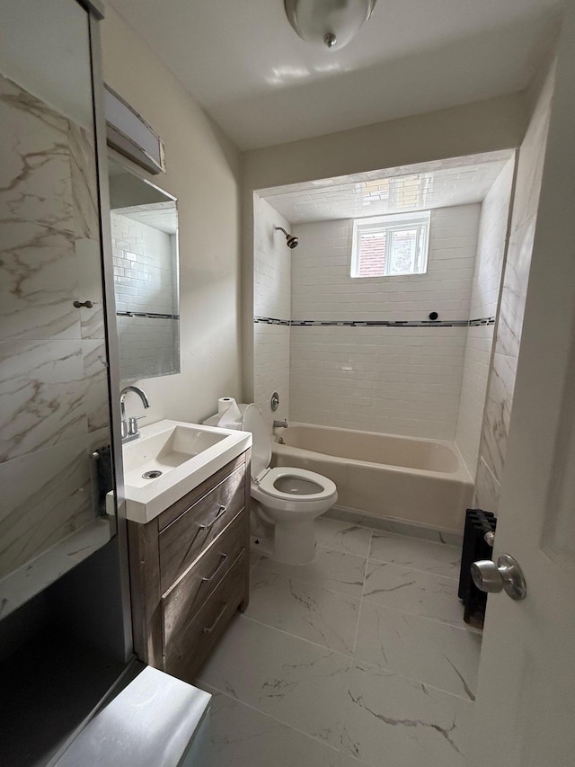 full bathroom with vanity, toilet, and tiled shower / bath