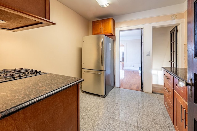 1059 Neill Ave, Bronx, NY 10461 - kitchen with freestanding refrigerator, range hood, brown cabinets, granite tiled floors, and dark stone counters