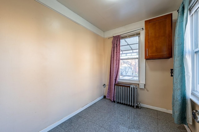 unfurnished room featuring radiator