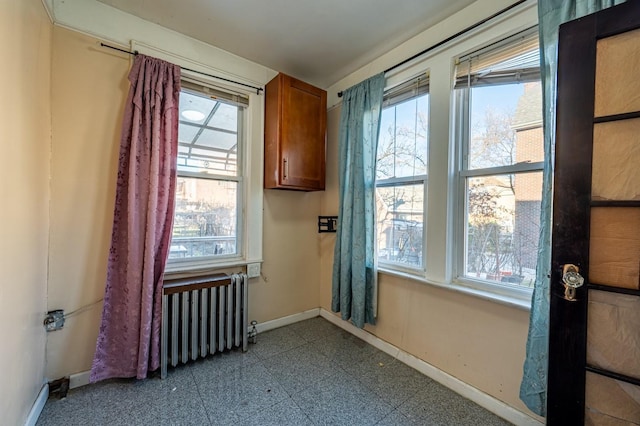 doorway with radiator heating unit and a wealth of natural light