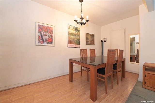 dining area featuring a chandelier and light hardwood / wood-style floors