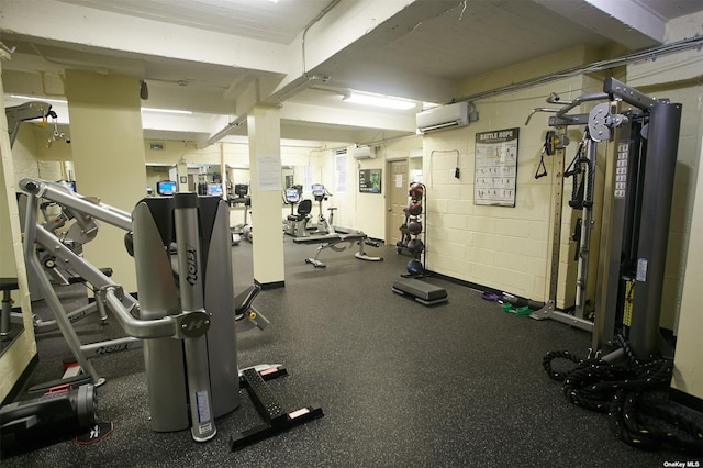 exercise room featuring an AC wall unit