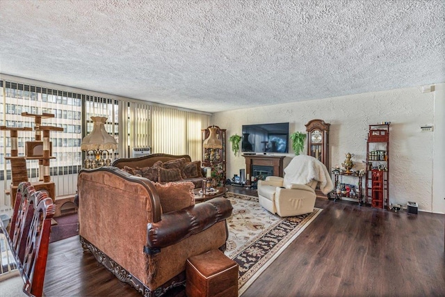 living room featuring radiator heating unit, dark wood-type flooring, and a textured ceiling