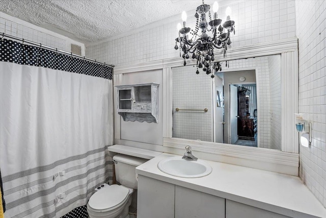 bathroom featuring vanity, toilet, tile walls, a textured ceiling, and walk in shower