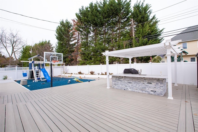 8 Lillian Ln, Plainview, NY 11803 - wooden deck featuring exterior kitchen, a fenced backyard, a pergola, and a playground