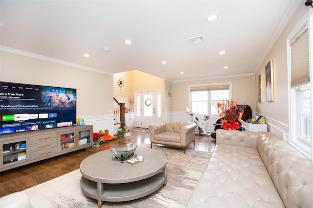 living room with wood-type flooring and ornamental molding