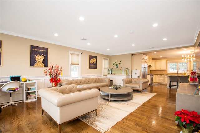 living room featuring wood-type flooring and crown molding