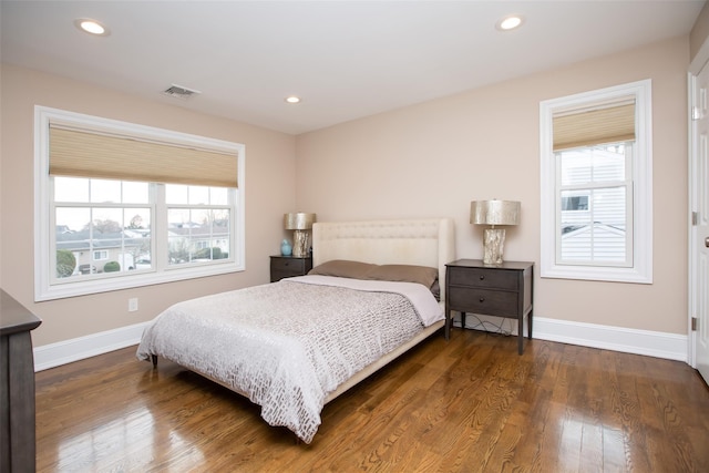 bedroom with dark hardwood / wood-style floors