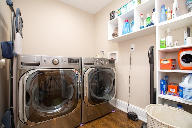 clothes washing area with separate washer and dryer and dark hardwood / wood-style floors