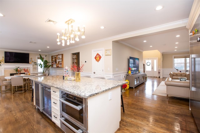 kitchen with pendant lighting, a center island, dark hardwood / wood-style flooring, and a breakfast bar area