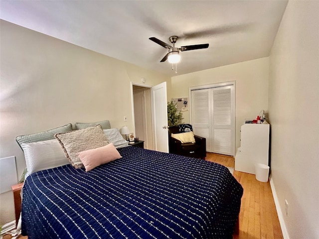 bedroom featuring ceiling fan, a closet, and light wood-type flooring