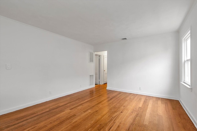 unfurnished room with light wood-type flooring