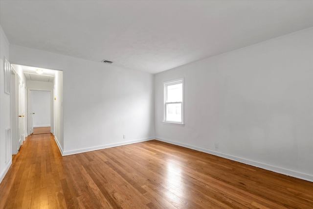 spare room with light hardwood / wood-style flooring