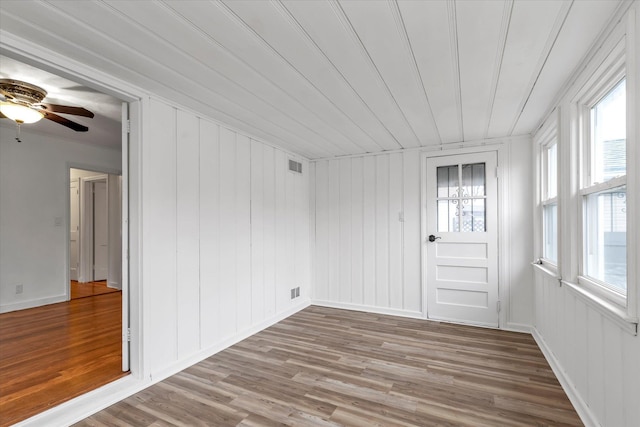 unfurnished sunroom with ceiling fan and plenty of natural light