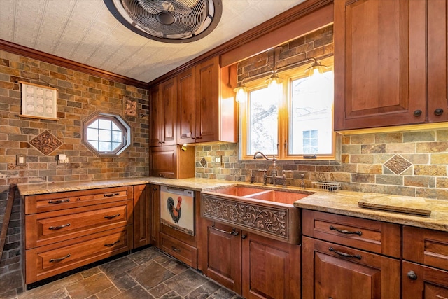 kitchen featuring sink, decorative backsplash, light stone counters, and crown molding