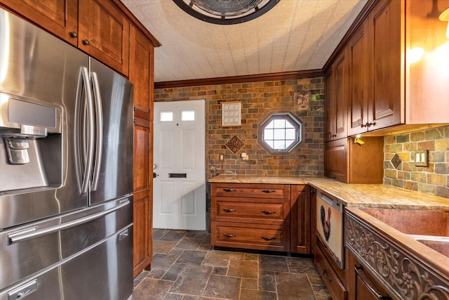 kitchen with stainless steel refrigerator with ice dispenser, tasteful backsplash, light stone counters, and crown molding