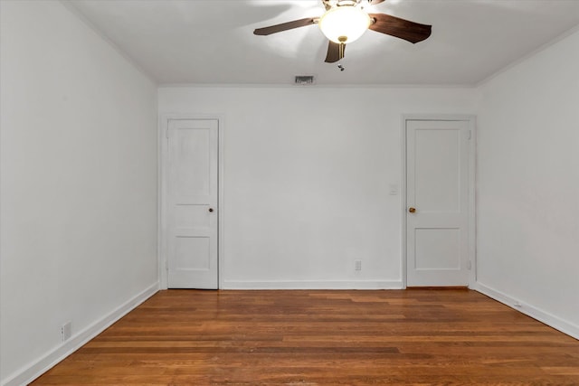 spare room with crown molding, ceiling fan, and hardwood / wood-style flooring