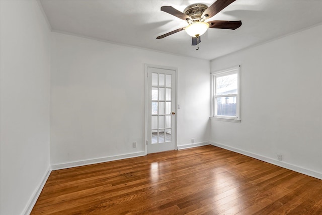 empty room featuring hardwood / wood-style flooring, ceiling fan, and ornamental molding