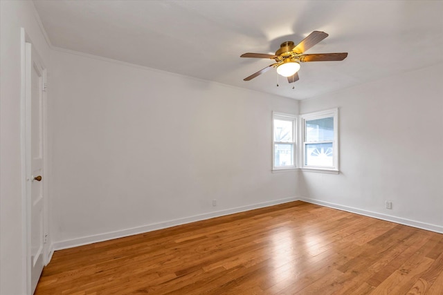 unfurnished room with ceiling fan, hardwood / wood-style floors, and crown molding