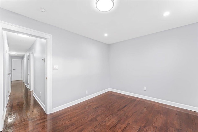 unfurnished room with dark hardwood / wood-style floors