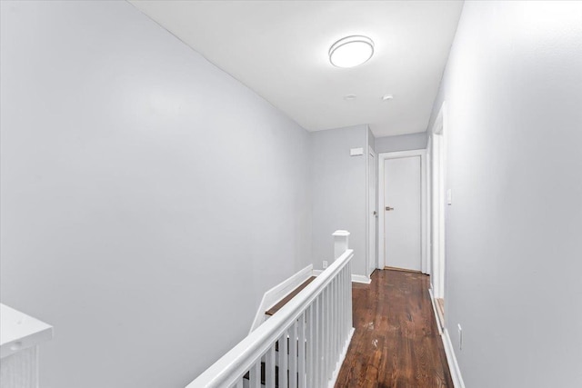 corridor with dark hardwood / wood-style flooring