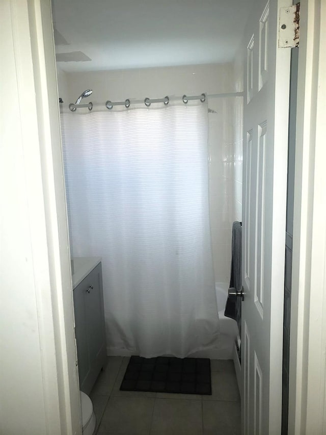 full bathroom with tile patterned flooring, vanity, shower / tub combo with curtain, and toilet