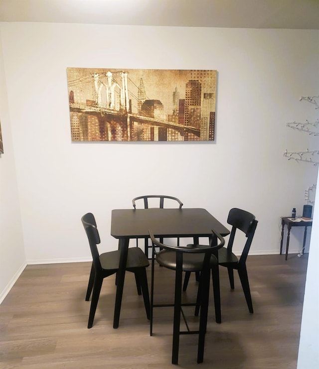 dining room with wood-type flooring